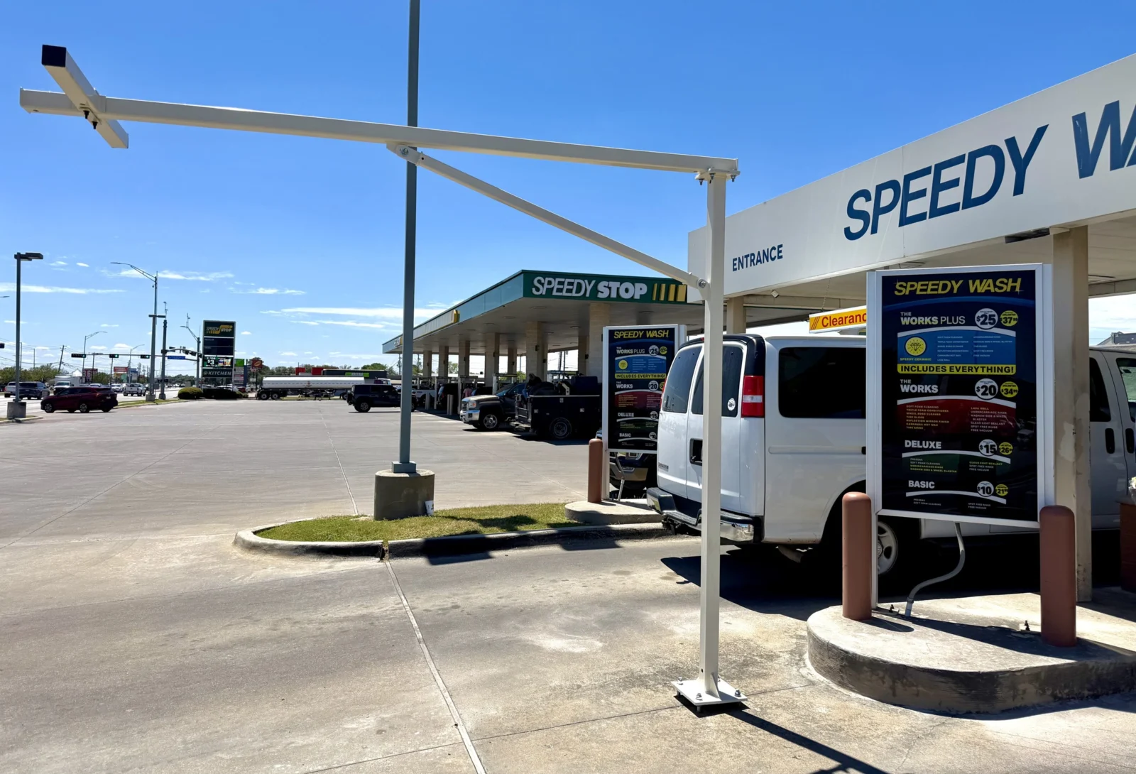 Steel camera pole arm over a car wash pay lane
