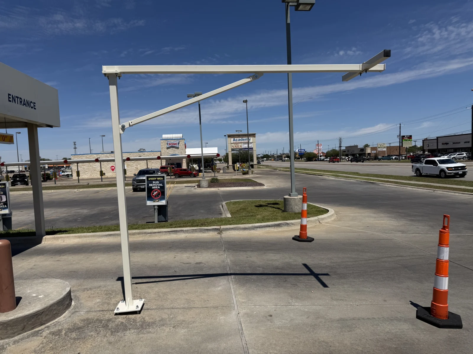 White steel camera pole at a car wash entrance