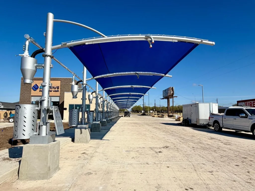 Blue cantilever vacuum canopy at an express car wash