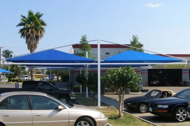 Four post cantilever shade structure over parking