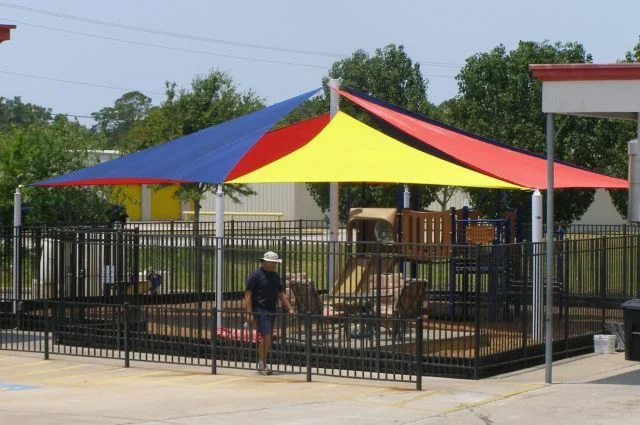 Four post shade structure over a playground