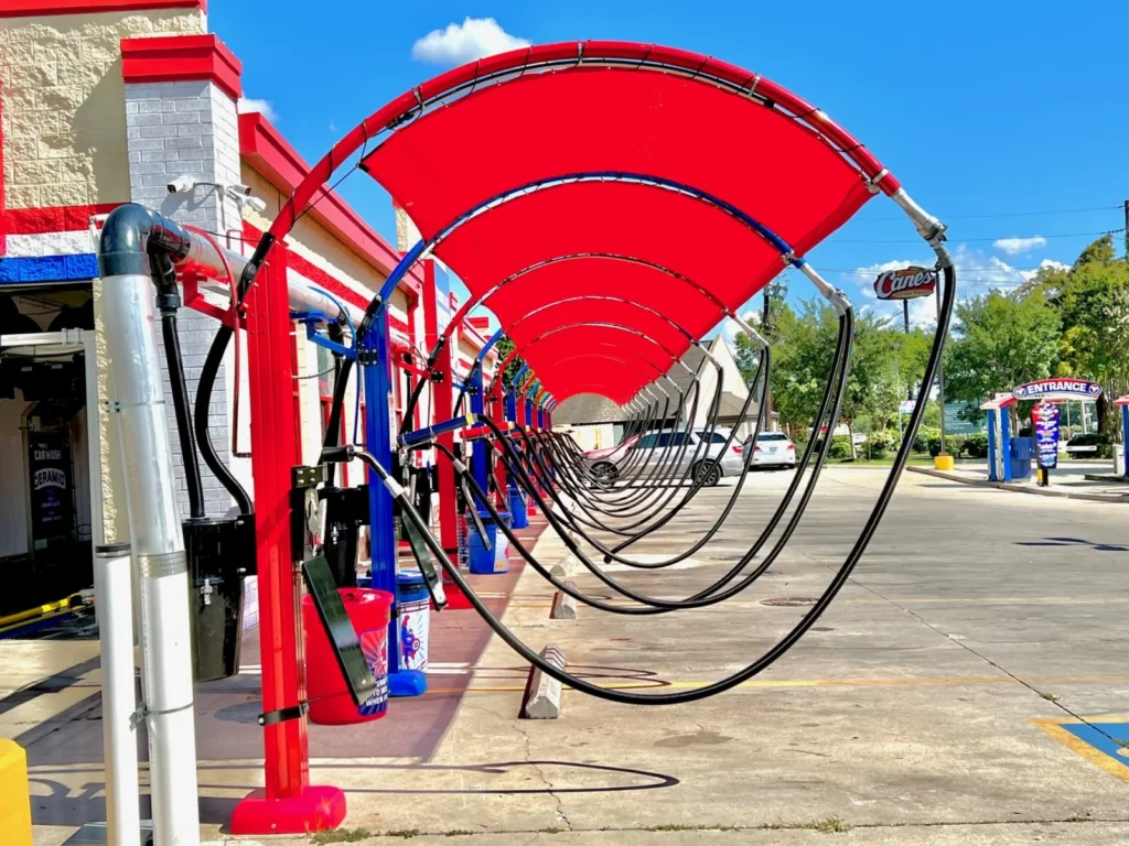 Red arched vacuum canopies at AmeriShine car wash