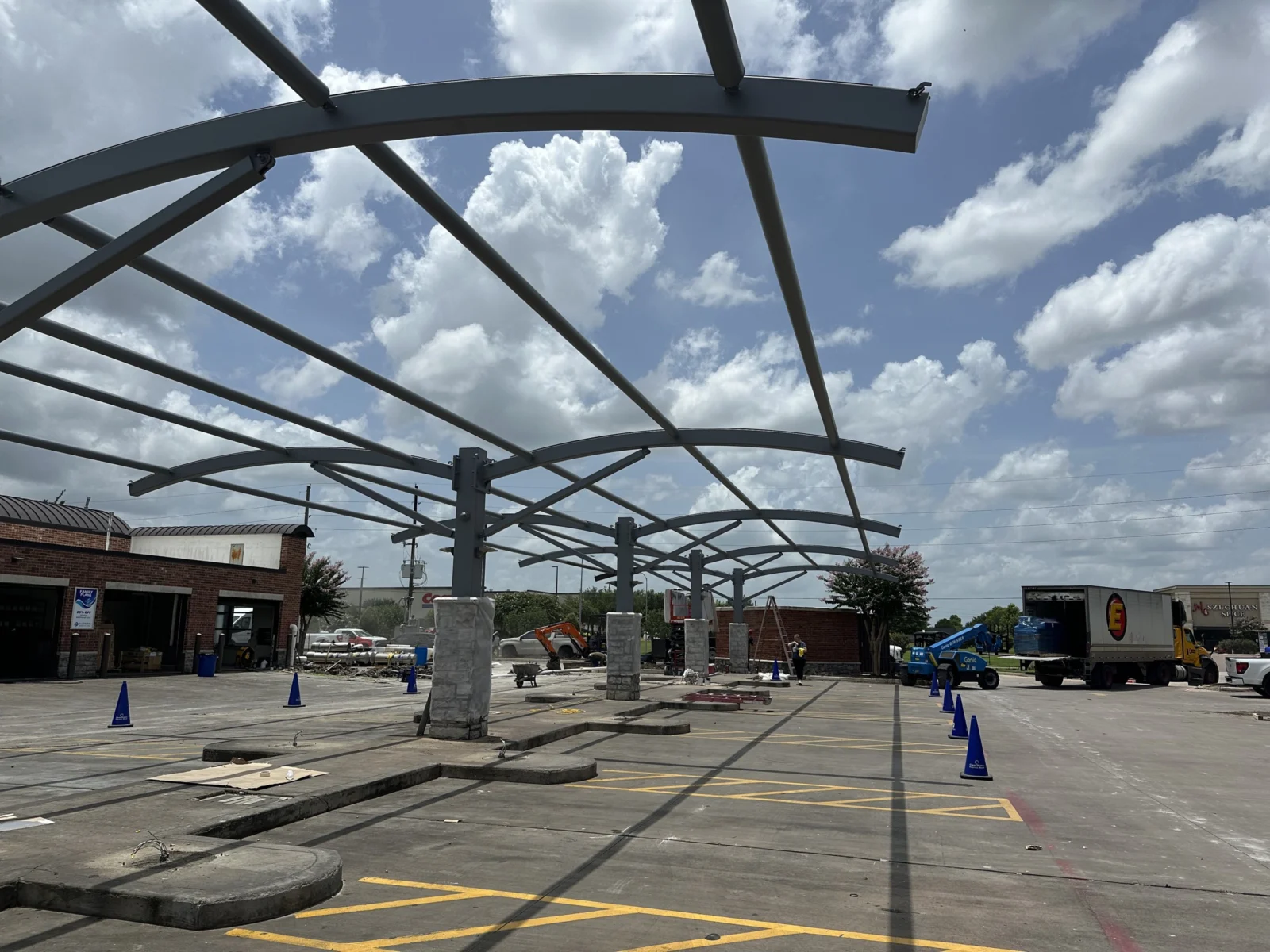 Curved steel canopy frames before fabric installation