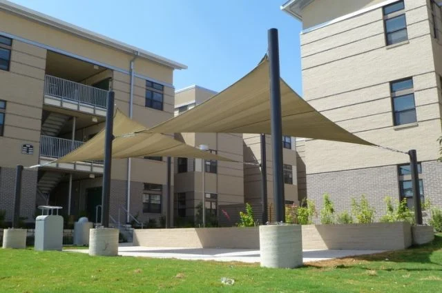 Triangle shade sails over a courtyard